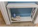 White shelf with an iron and ironing board, perfect for guests at 2200 W Moffat Pl, Denver, CO 80221