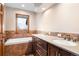 Bathroom with double sinks, soaking tub and tile flooring at 5378 Hawthorn Trl, Littleton, CO 80125