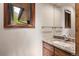 Bathroom with granite countertop, single sink and wood cabinet at 5378 Hawthorn Trl, Littleton, CO 80125