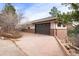 Attached garage with brick exterior at 5378 Hawthorn Trl, Littleton, CO 80125