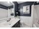 Clean bathroom with dark vanity, white subway tile, and a shower/tub combo at 2118 S Truckee St, Aurora, CO 80013