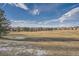 Community park with grassy areas and distant mountains at 15505 Carob Cir, Parker, CO 80134