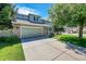 Two-story home with a landscaped lawn and attached garage at 6109 S Kirk St, Centennial, CO 80016