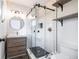 Modern bathroom with white subway tile, glass shower, and wood vanity at 3423 S Vrain St, Denver, CO 80236