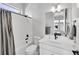 Clean bathroom with a tub shower combo and white vanity at 18352 W 95Th Pl, Arvada, CO 80007