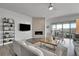 Spacious living room featuring a fireplace and sliding glass doors leading to a deck with mountain views at 18352 W 95Th Pl, Arvada, CO 80007