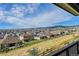 View of the community from a backyard deck showcasing homes and mountains at 18352 W 95Th Pl, Arvada, CO 80007