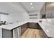 Modern basement wet bar with quartz countertops and wine rack at 18352 W 95Th Pl, Arvada, CO 80007