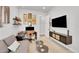 Home office with a desk, comfortable seating, and large screen TV at 18352 W 95Th Pl, Arvada, CO 80007