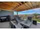 Covered patio with hot tub, seating area, and fire pit at 18352 W 95Th Pl, Arvada, CO 80007