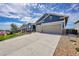 Two-story home with a three-car garage and landscaped front yard at 18352 W 95Th Pl, Arvada, CO 80007