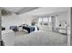 Spacious basement bedroom with large windows and sitting area at 18352 W 95Th Pl, Arvada, CO 80007