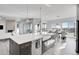 Modern kitchen with large island, farmhouse sink, and stainless steel appliances at 18352 W 95Th Pl, Arvada, CO 80007