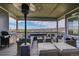 Spacious covered patio with comfortable seating and a grill at 18352 W 95Th Pl, Arvada, CO 80007