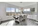 Dining area with large windows offering scenic views and modern light fixture at 18352 W 95Th Pl, Arvada, CO 80007