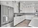 Modern kitchen with white cabinets, stainless steel appliances, and quartz countertops at 18352 W 95Th Pl, Arvada, CO 80007