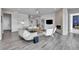 Open living area with gray hardwood floors and a corner fireplace at 18352 W 95Th Pl, Arvada, CO 80007