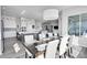 Bright kitchen features white cabinetry, an island, and stainless steel appliances at 18352 W 95Th Pl, Arvada, CO 80007