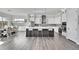 Modern kitchen with island, stainless steel appliances, and white cabinets at 18352 W 95Th Pl, Arvada, CO 80007