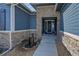 Front entrance with stone accents and water feature at 18352 W 95Th Pl, Arvada, CO 80007