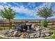 Landscaped backyard with a charming rock waterfall feature at 18352 W 95Th Pl, Arvada, CO 80007