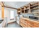 Kitchen with wood cabinets and stone backsplash at 2933 W Short Pl, Denver, CO 80204