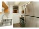Bright kitchen features stainless steel appliances and double sink at 44 N Lincoln St, Denver, CO 80203