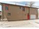 Tan brick building with red door and detached garage at 44 N Lincoln St, Denver, CO 80203