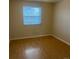 Bright bedroom featuring laminate flooring and a window at 1080 S Garrison St, Lakewood, CO 80226