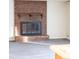 Brick fireplace with a glass-front and wood mantel at 1080 S Garrison St, Lakewood, CO 80226