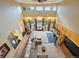 Spacious living room with high ceilings, seating area, fireplace, and views of the backyard pool at 29115 Summit Ranch Dr, Golden, CO 80401