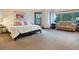 Large main bedroom with plush bed, sitting area, and access to balcony at 29115 Summit Ranch Dr, Golden, CO 80401