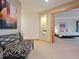 Elegant hallway with a bench and glimpse into a spacious bedroom at 29115 Summit Ranch Dr, Golden, CO 80401