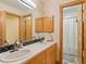 Shared bathroom with double sink vanity and shower/tub combo at 29115 Summit Ranch Dr, Golden, CO 80401