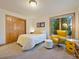 Spacious bedroom with double door closet, large window, and yellow chair at 29115 Summit Ranch Dr, Golden, CO 80401