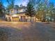 Two-story house with a three-car garage and landscaping at dusk at 29115 Summit Ranch Dr, Golden, CO 80401
