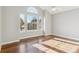 Light-filled bedroom with hardwood floors and an arched window at 2503 S Toledo Way, Aurora, CO 80014