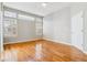 Hardwood floor bedroom with large windows and neutral wall color at 2503 S Toledo Way, Aurora, CO 80014