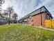 Brick building with landscaping and a tree in the front at 7050 W Cedar Ave # 108, Lakewood, CO 80226