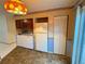 Galley kitchen with washer, dryer, and refrigerator at 7050 W Cedar Ave # 108, Lakewood, CO 80226