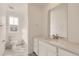 Clean bathroom with white vanity, bathtub, and marble-look flooring at 4847 Aster Way, Brighton, CO 80601