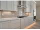 Modern kitchen features white cabinets, quartz countertops, and stainless steel appliances at 23845 E River Front Dr, Aurora, CO 80019