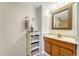 Bathroom features a vanity with wood cabinets and a large mirror at 6215 Northwoods Glen Dr, Parker, CO 80134