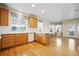 Kitchen with wood cabinets, hardwood floors and island at 114 Apache Plume St, Brighton, CO 80601