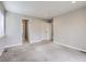 Well-lit bedroom with carpet flooring and access to a bathroom at 3460 Birch St, Denver, CO 80207