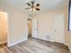 Bedroom with wood-look floors, ceiling fan, and access to bathroom at 1297 Worchester St, Aurora, CO 80011