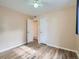 Bedroom with wood-look floors, ceiling fan, and access to bathroom at 1297 Worchester St, Aurora, CO 80011