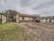 Tan house with red door and mature trees at 1297 Worchester St, Aurora, CO 80011