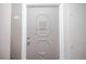 Gray front door with ornate detailing and silver hardware at 9155 E Center Ave # 4B, Denver, CO 80247
