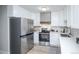 Modern kitchen featuring stainless steel appliances and white cabinets at 9155 E Center Ave # 4B, Denver, CO 80247